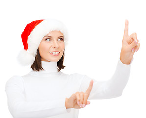 Image showing woman in santa helper hat pressing vitrual button