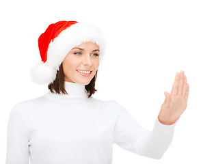 Image showing woman in santa helper hat pressing vitrual button