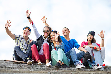 Image showing group of teenagers waving hands