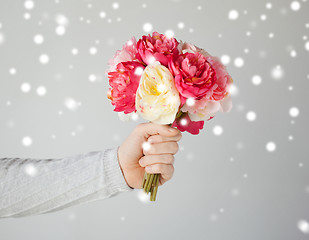 Image showing man holding bouquet of flowers