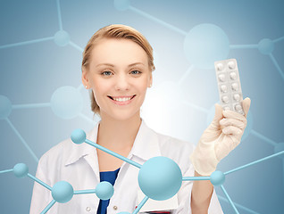 Image showing attractive female doctor with pills