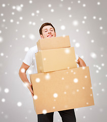 Image showing young man carrying carton boxes