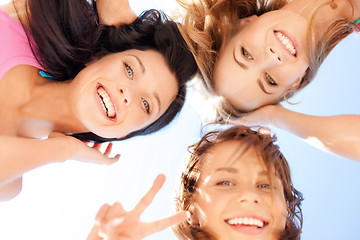 Image showing girls faces with shades looking down