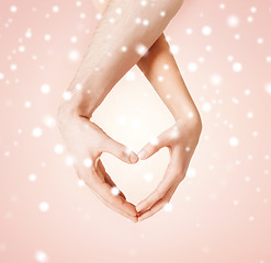 Image showing woman and man hands showing heart shape