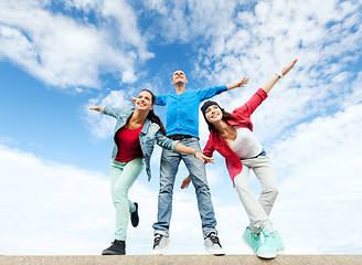 Image showing group of teenagers spreading hands