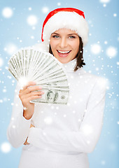 Image showing woman in santa helper hat with us dollar money