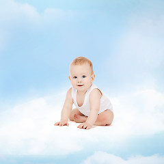 Image showing smiling baby sitting on the cloud