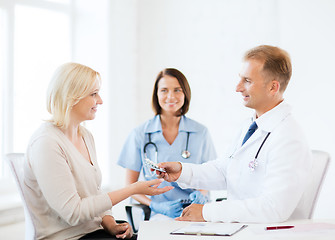 Image showing doctor giving tablets to patient in hospital