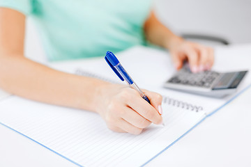 Image showing businesswoman working with calculator in office