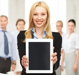 Image showing smiling woman with tablet pc in office