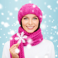 Image showing woman in hat and muffler with big snowflake