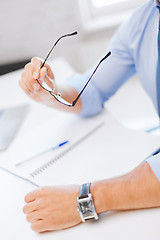 Image showing businessman with spectacles writing in notebook