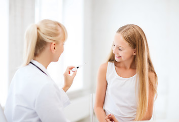 Image showing doctor with child measuring temperature