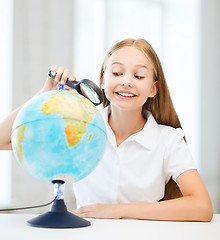 Image showing child looking at globe with magnifier