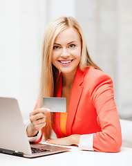 Image showing businesswoman with laptop using credit card