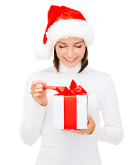 Image showing smiling woman in santa helper hat with gift box