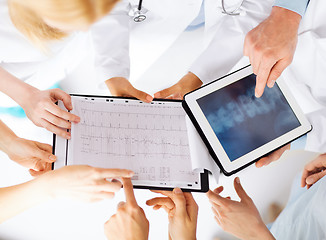 Image showing group of doctors looking at x-ray on tablet pc