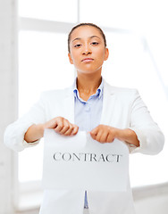 Image showing african businesswoman tearing contract