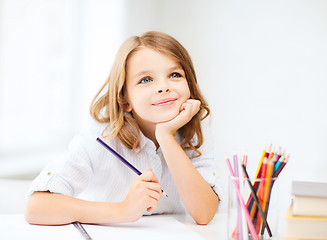 Image showing girl drawing with pencils at school