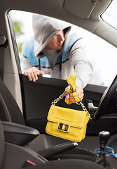 Image showing thief stealing bag from the car