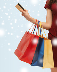 Image showing woman with shopping bags and credit card