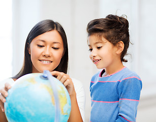 Image showing mother and daughter with globe