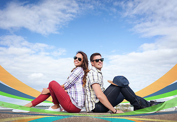 Image showing teenagers sitting back to back