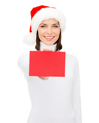 Image showing woman in santa helper hat with blank red card