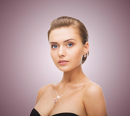 Image showing woman wearing shiny diamond earrings and pendant