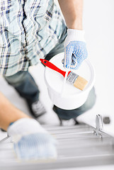 Image showing man with paintbrush, pot and ladder