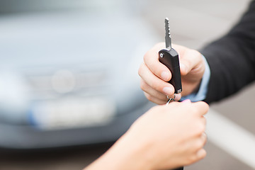 Image showing customer and salesman with car key