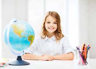 Image showing student girl with globe at school