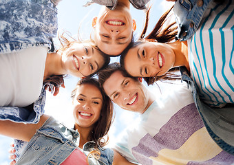 Image showing group of teenagers looking down