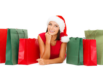 Image showing woman in red shirt with shopping bags