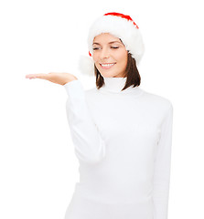 Image showing woman in santa helper hat with something on palm