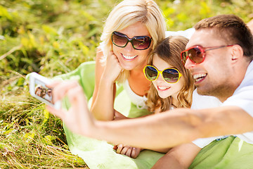 Image showing happy family with camera taking picture