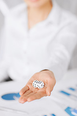 Image showing man hands with gambling dices signing contract