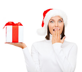 Image showing surprised woman in santa helper hat with gift box