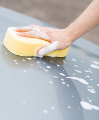 Image showing man washing a car