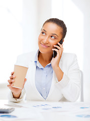 Image showing african businesswoman with smartphone in office