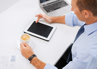 Image showing businessman with tablet pc and coffee in office