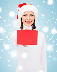 Image showing woman in santa helper hat with blank red card