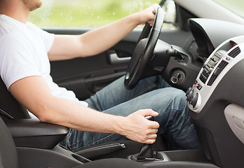 Image showing man shifting the gear on car manual gearbox