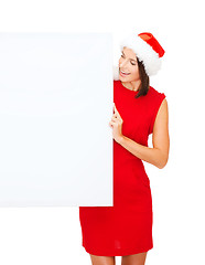 Image showing woman in santa helper hat with blank white board