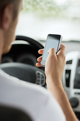 Image showing man using phone while driving the car