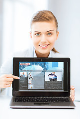 Image showing woman showing laptop pc with news