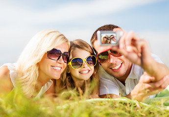 Image showing happy family with camera taking picture