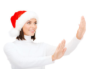 Image showing smiling woman in santa helper hat