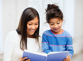 Image showing mother and daughter with book