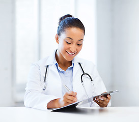 Image showing female doctor writing prescription